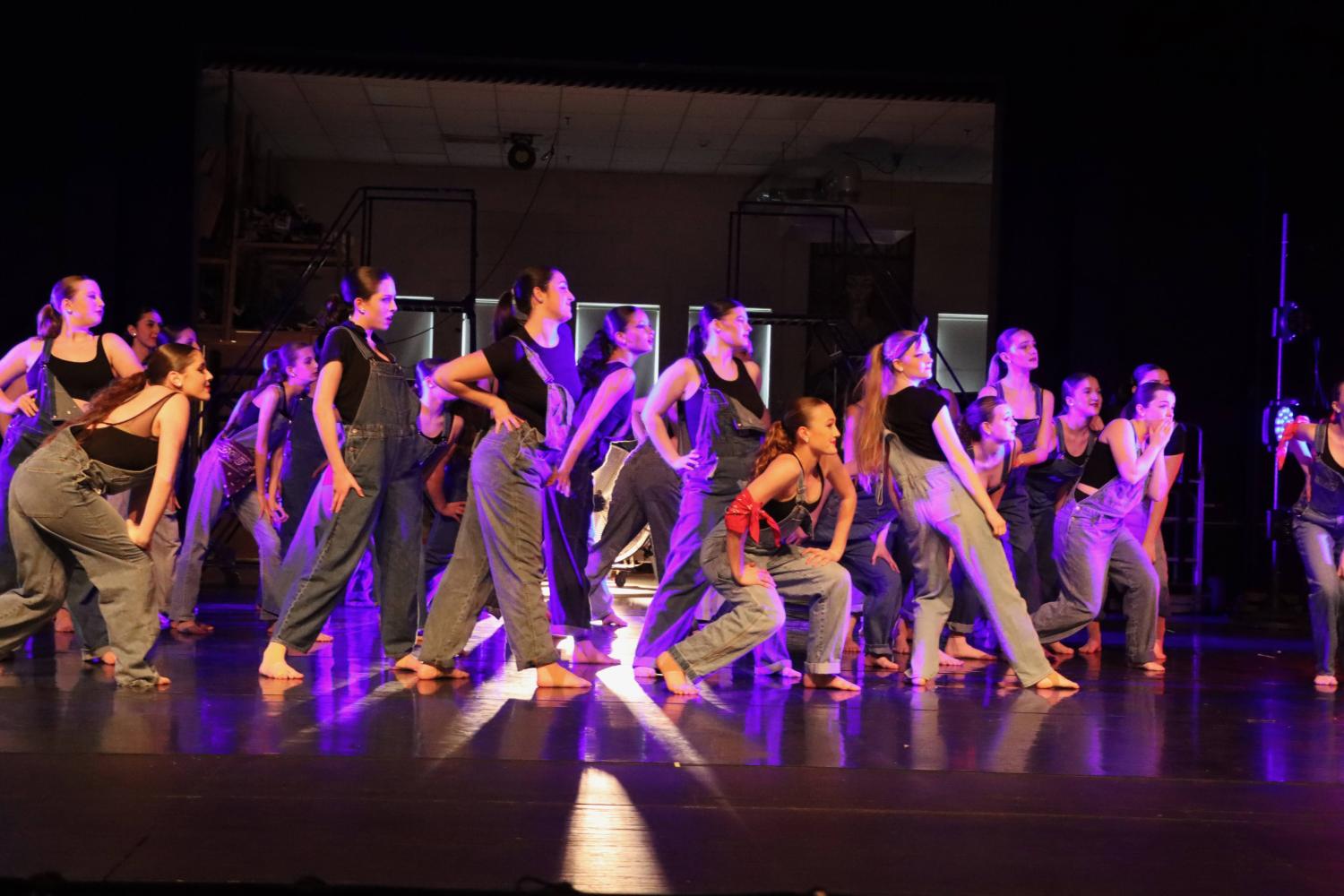 Dancers dressed in overalls 